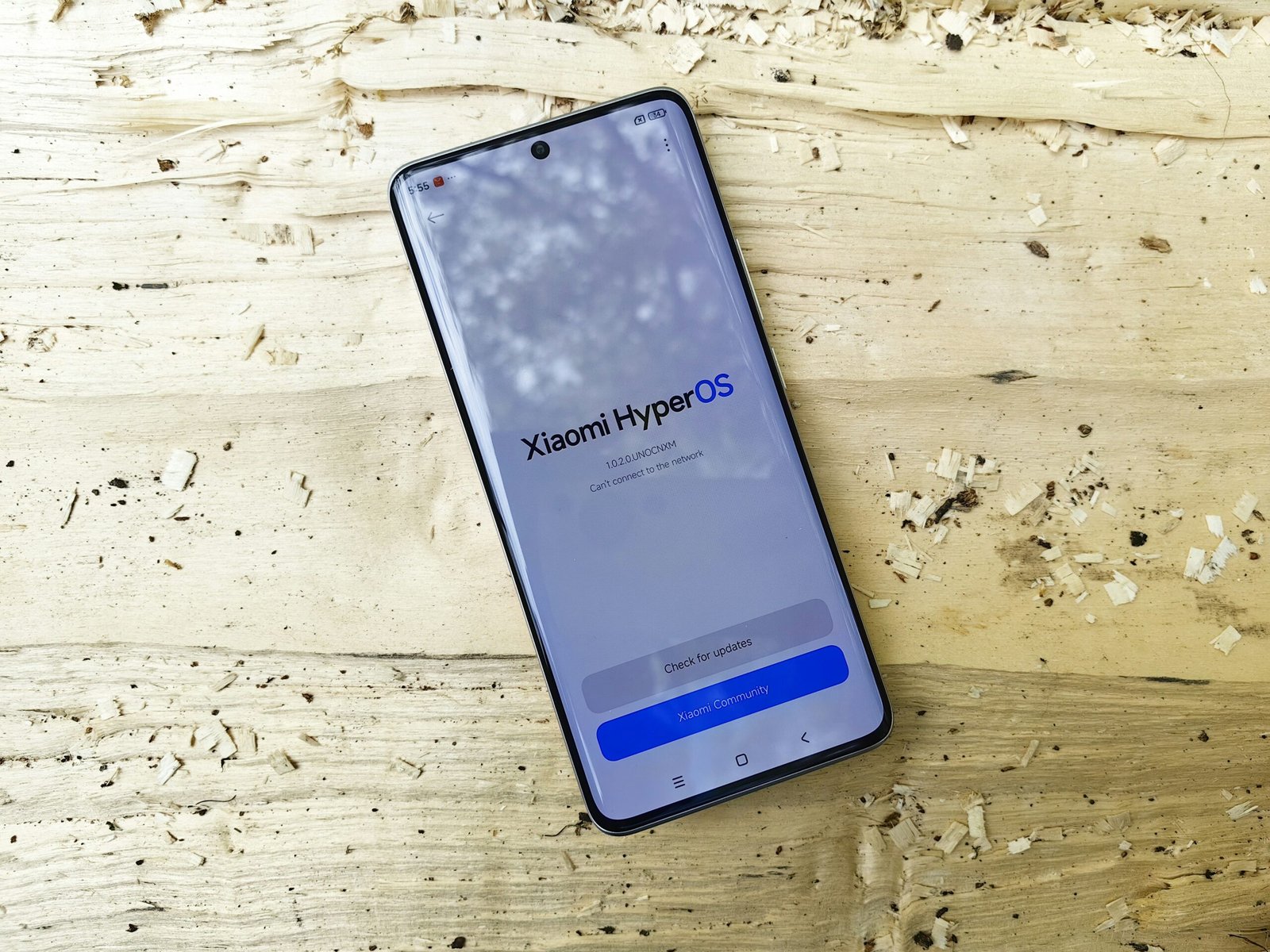 A cell phone sitting on top of a wooden table