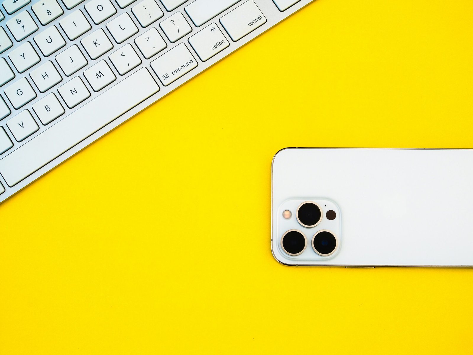 a white iphone sitting on top of a yellow table