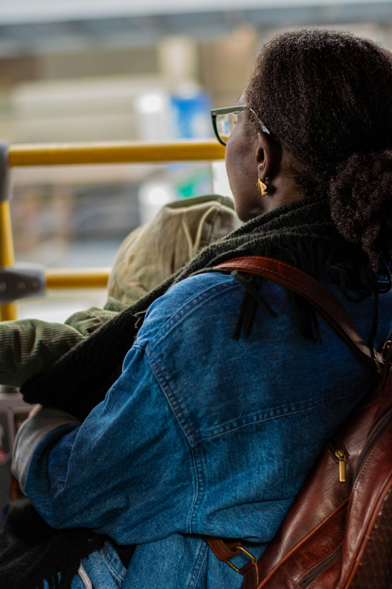 A woman sitting on a bus with a child on her lap